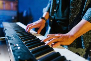 A man playing music on a keyboard